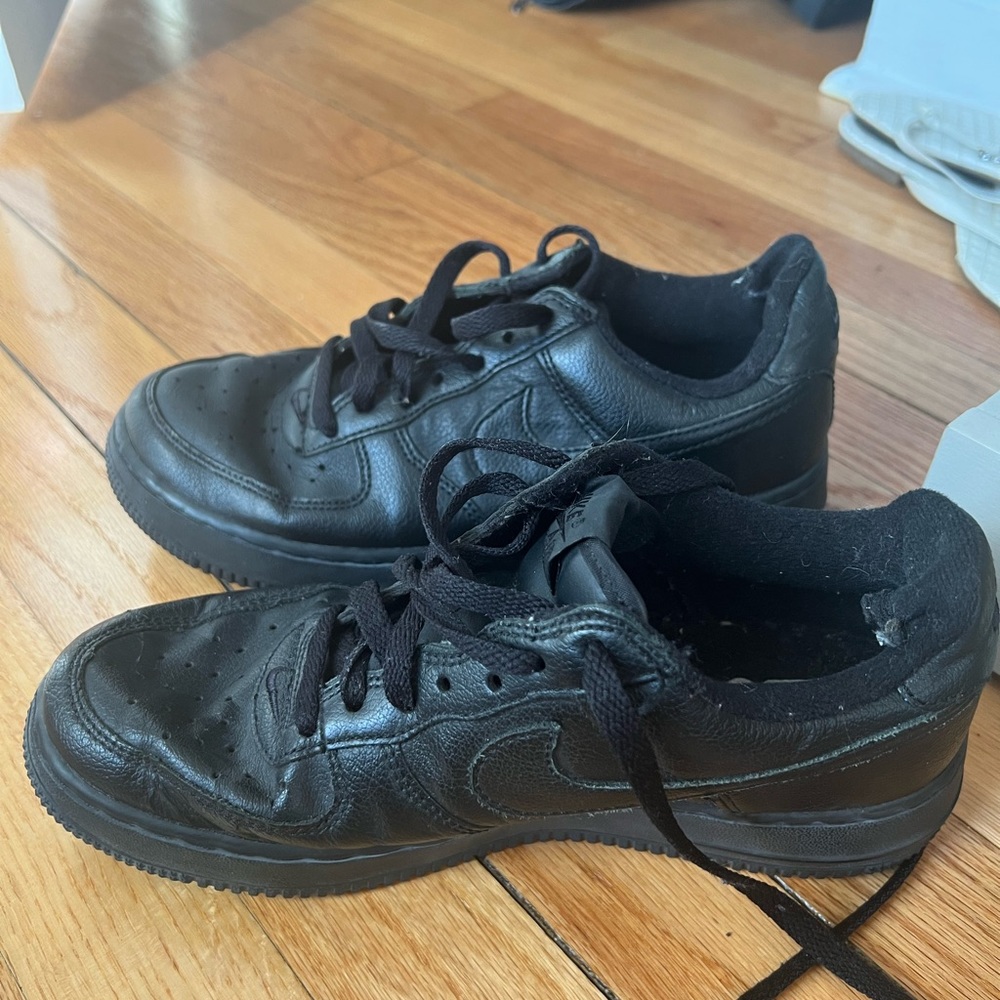 Nike Air Force ones. Kid size but can be woman’s 8